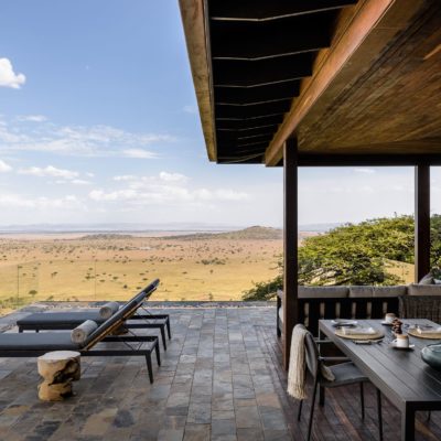 Singita Sasakwa Lodge - Hillside suite dining on the deck with a view